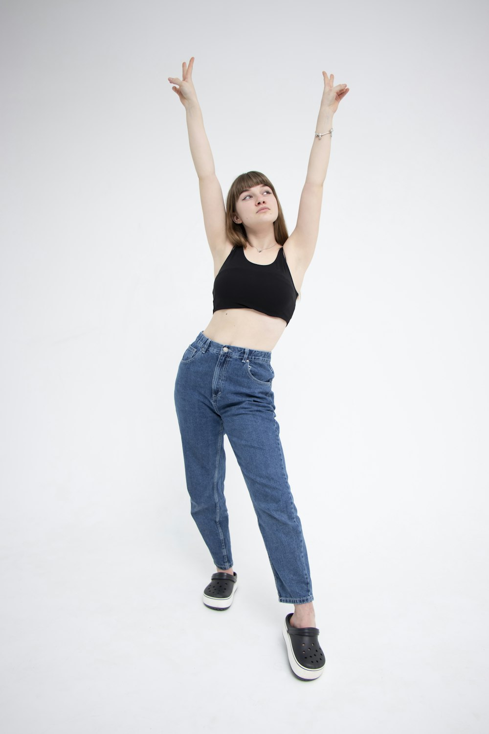 woman in black sports bra and blue denim jeans