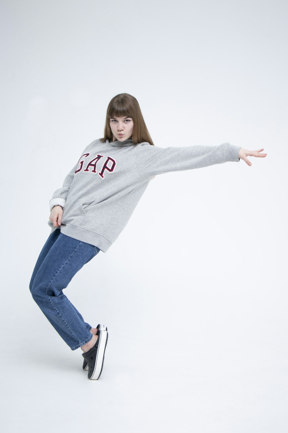 woman in gray sweater and blue denim jeans