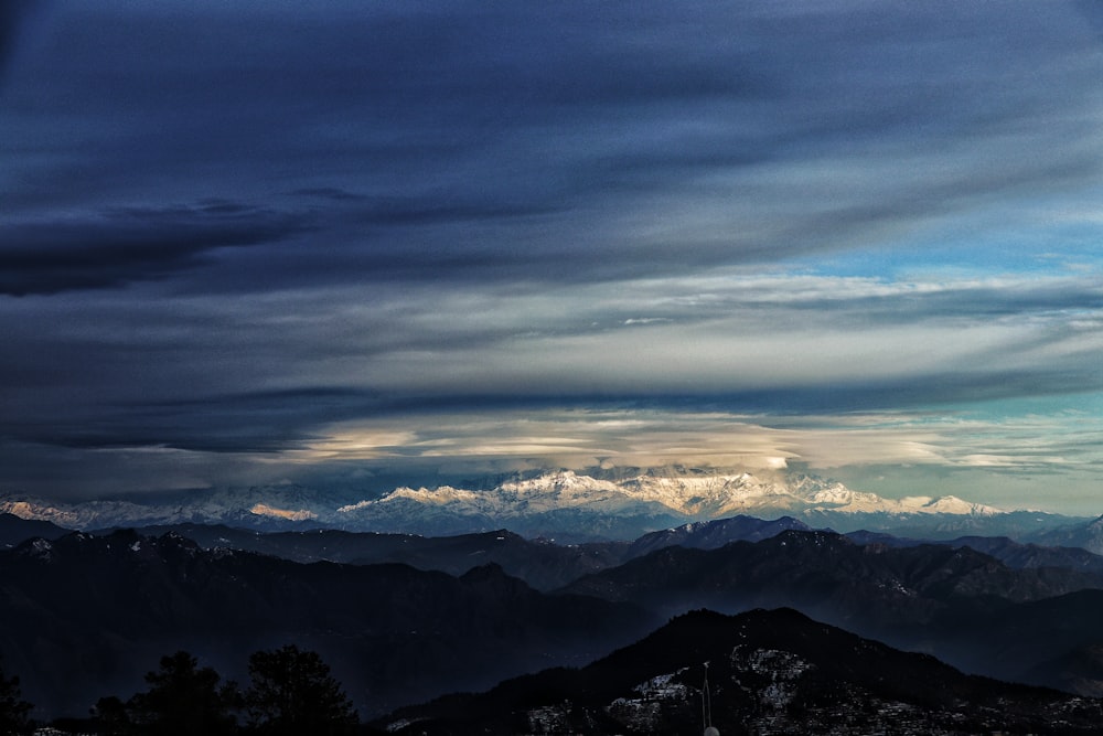 mountains under white clouds during daytime