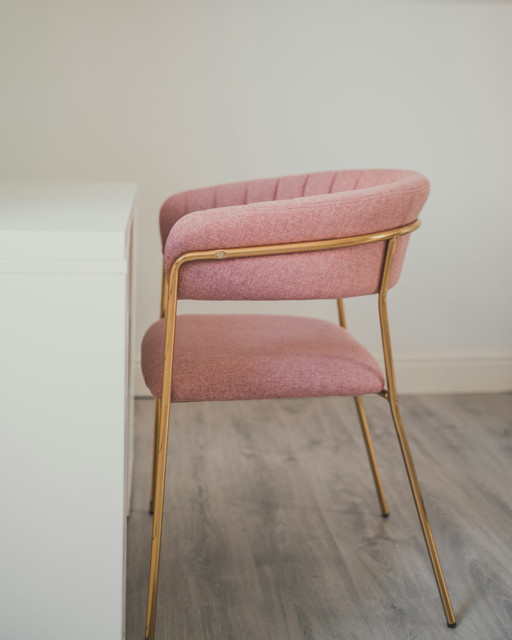 brown wooden framed pink padded chair