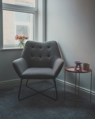 gray sofa chair beside glass window