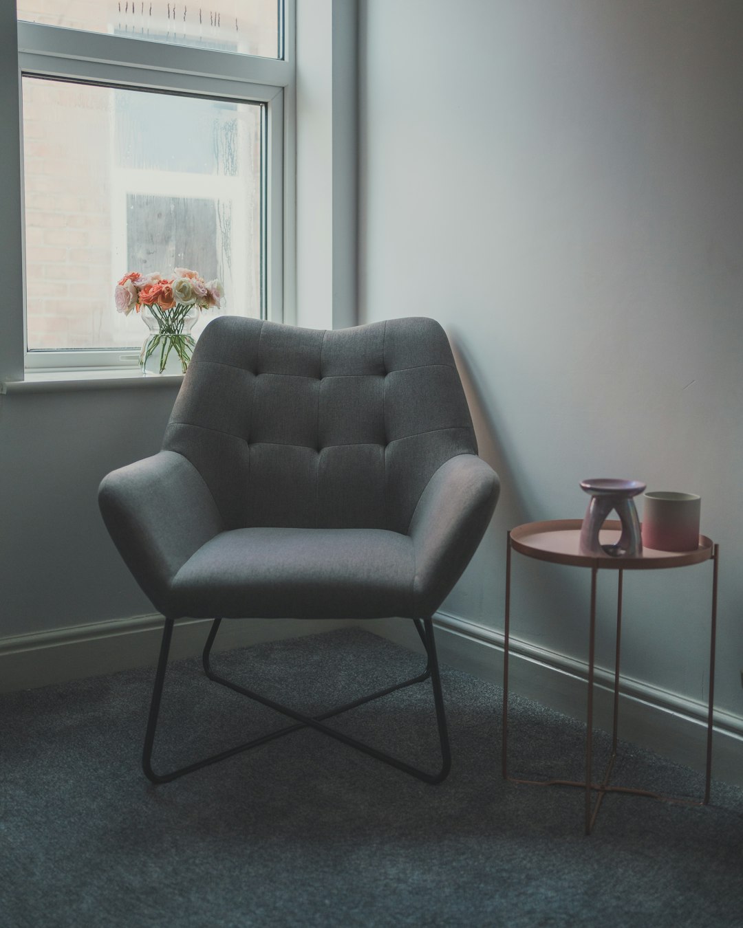 gray sofa chair beside glass window