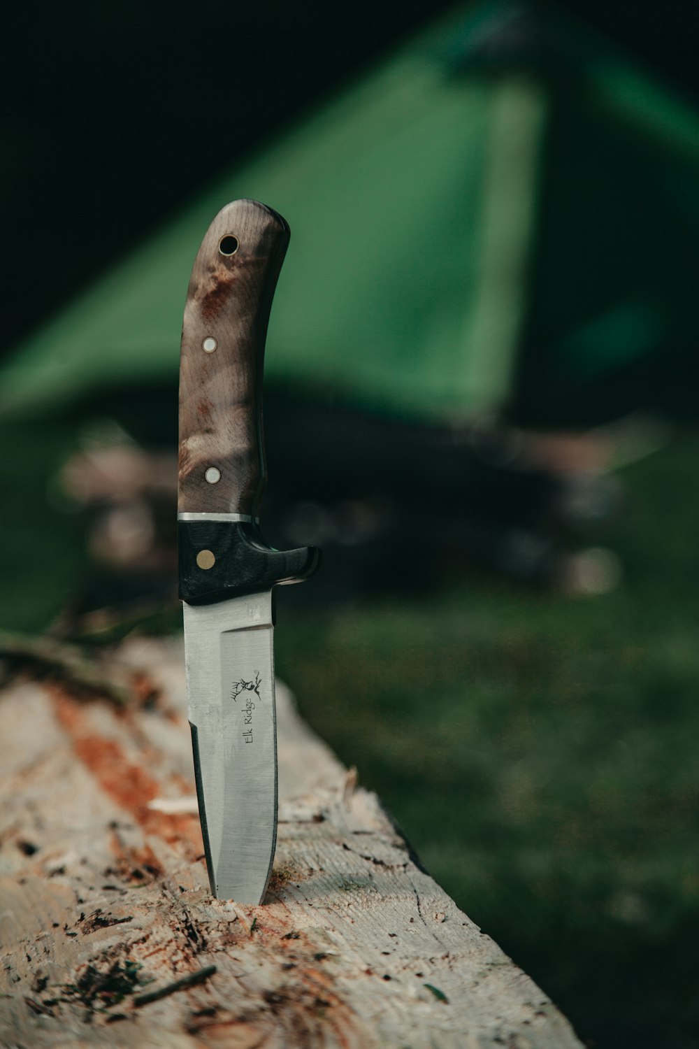 black handle knife on brown rock