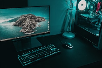 black flat screen computer monitor beside black computer keyboard