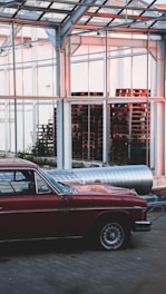 red car parked near building