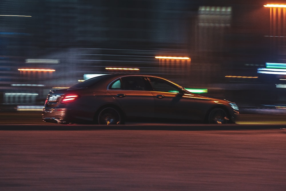 red sedan on road during night time