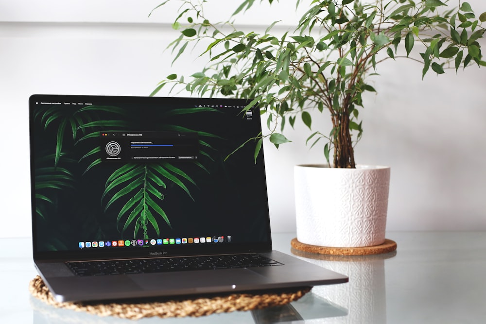 black laptop computer on brown wooden table