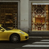 yellow ferrari 458 italia parked beside white concrete building