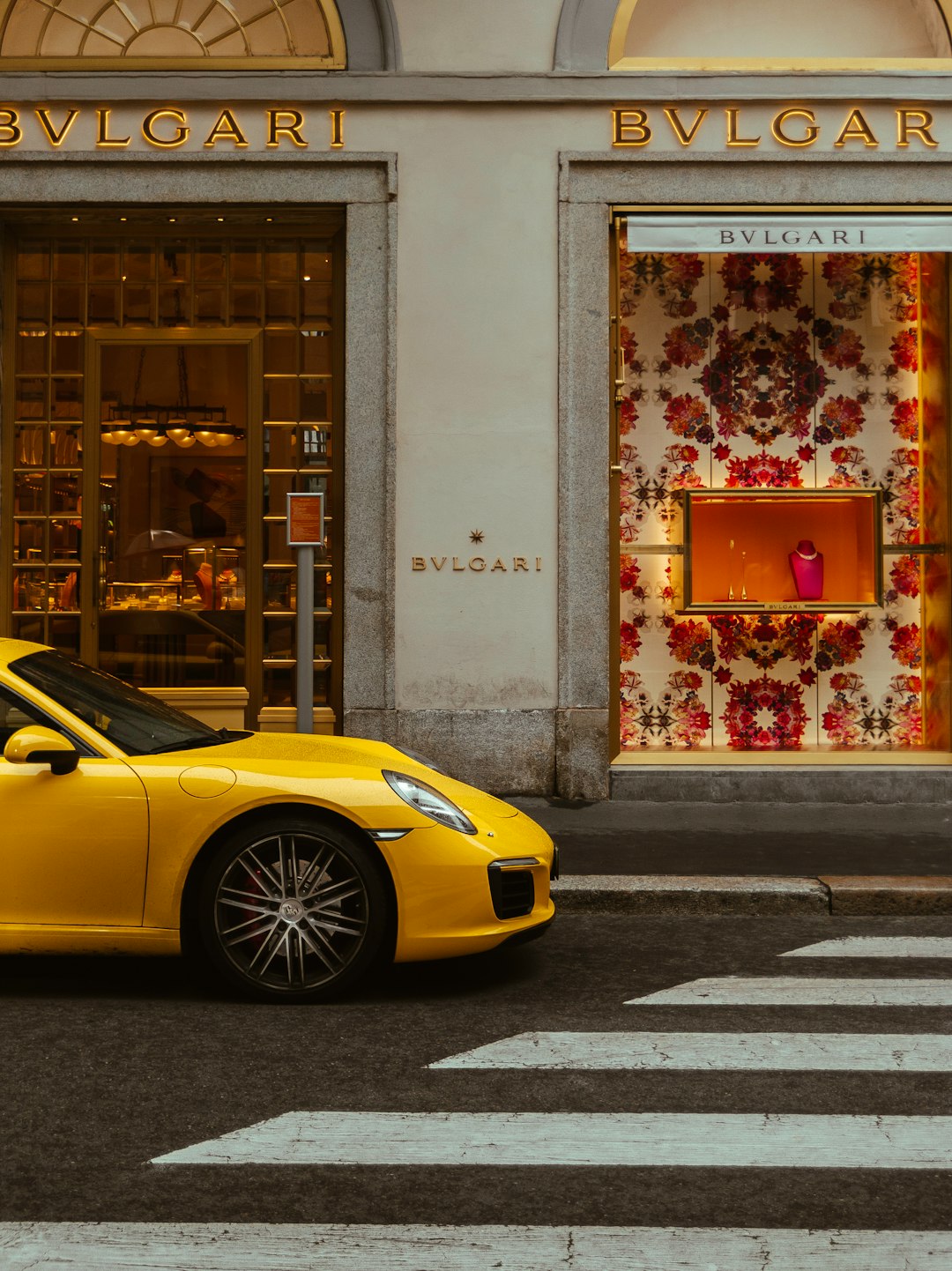 yellow ferrari 458 italia parked beside white concrete building