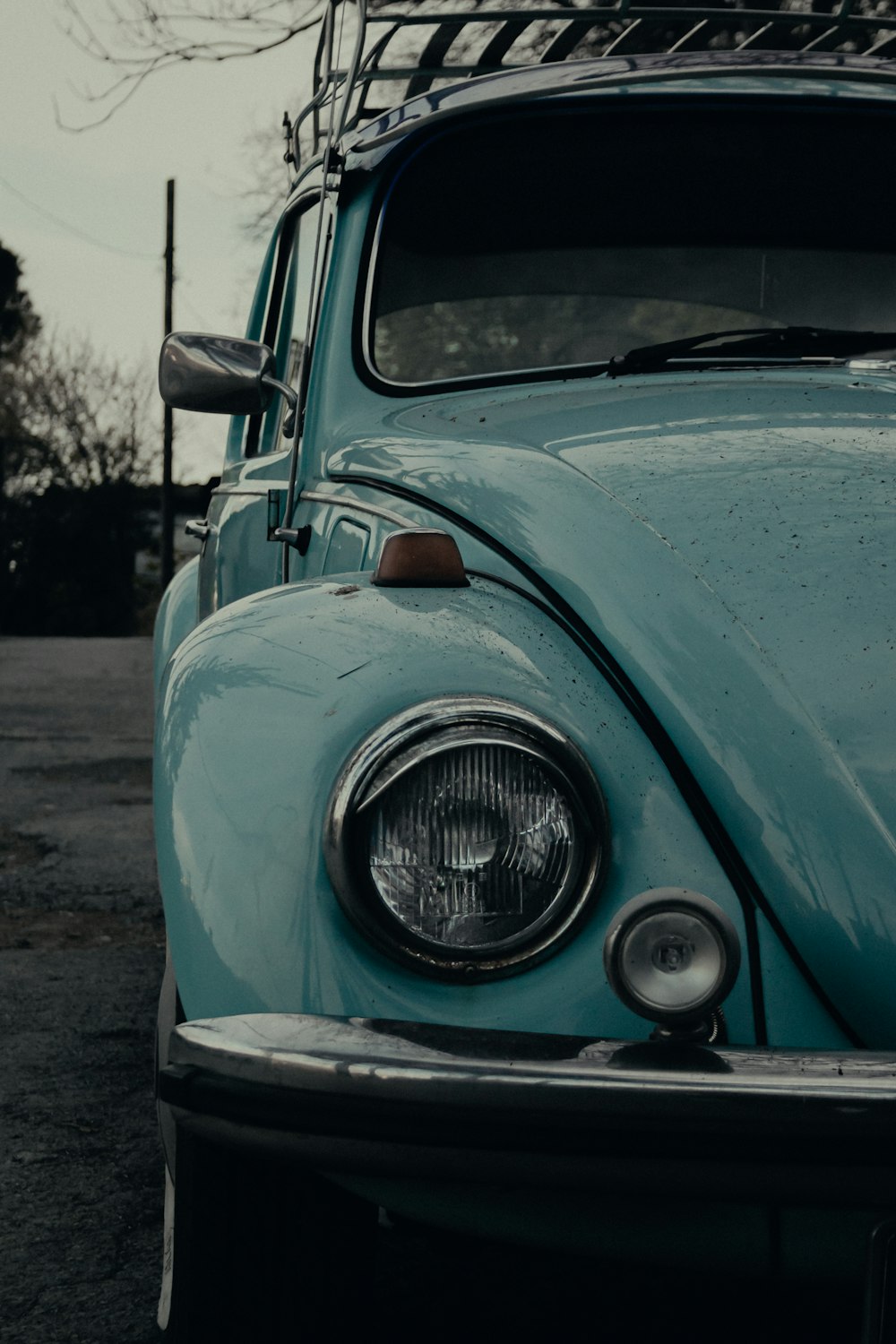 blue car on gray asphalt road during daytime