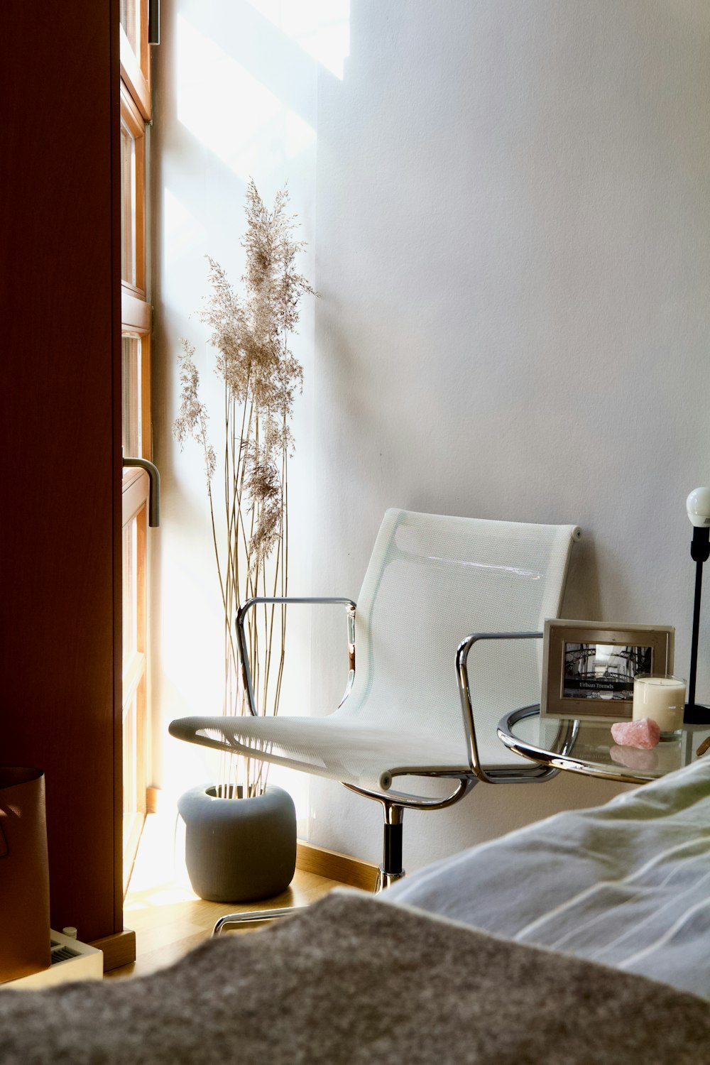 white and black armchair beside white wall