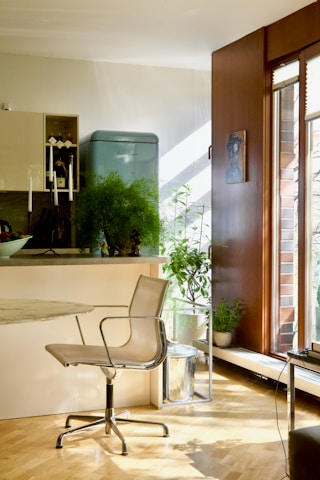 A bright, modern modular kitchen and office setup with clean lines and natural light.