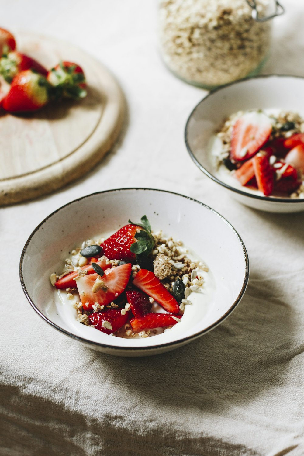 sliced strawberries on white ceramic bowl