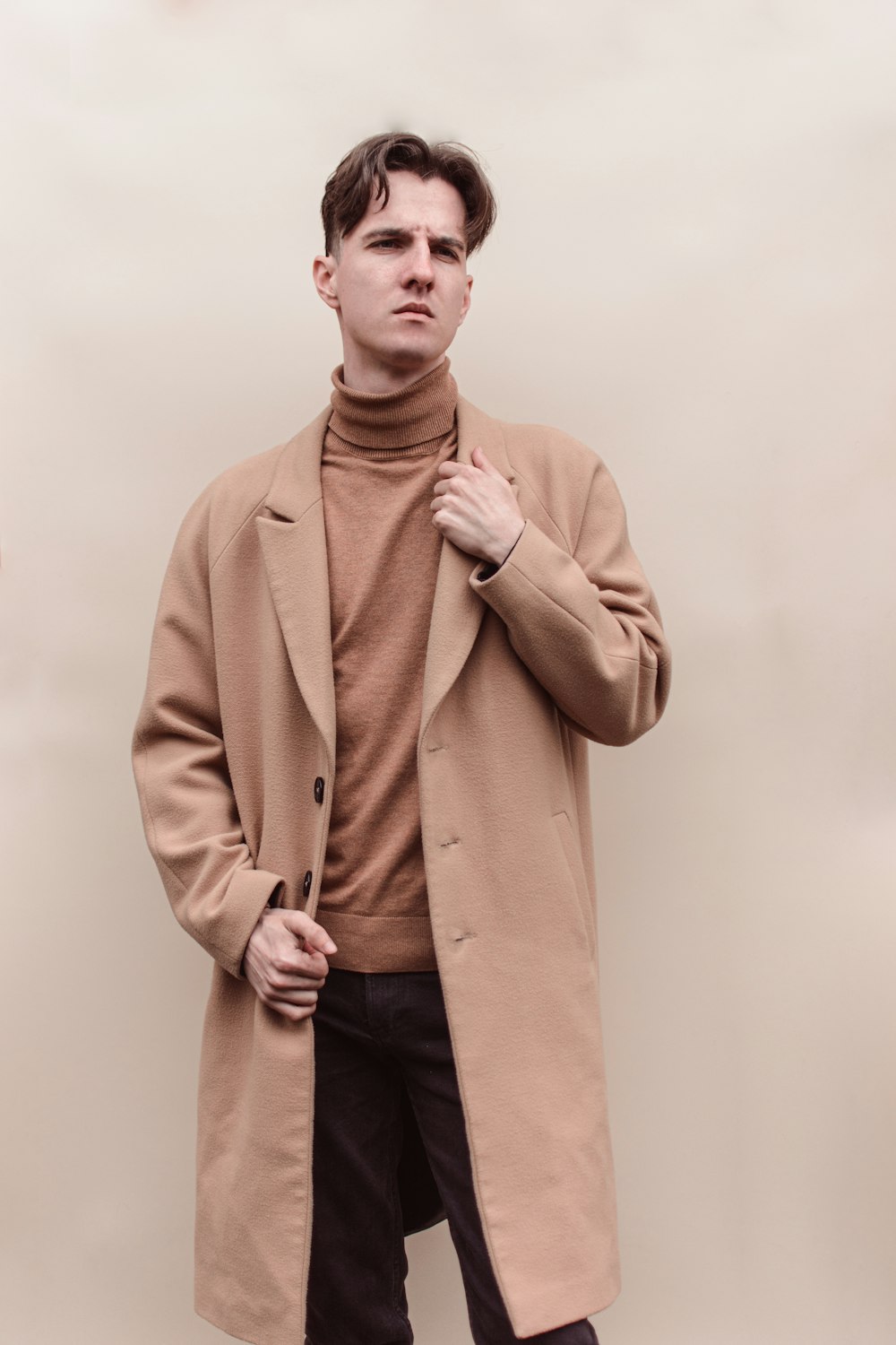 man in brown coat standing