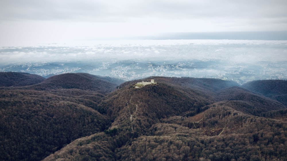 brown and green mountains under white clouds during daytime