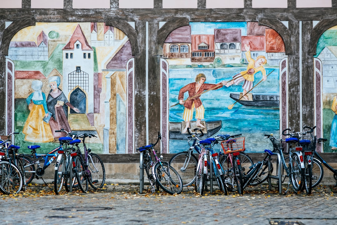 black bicycle parked beside brown concrete building during daytime