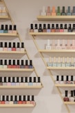 A cozy nail salon corner with colorful nail polish bottles neatly arranged on shelves.
