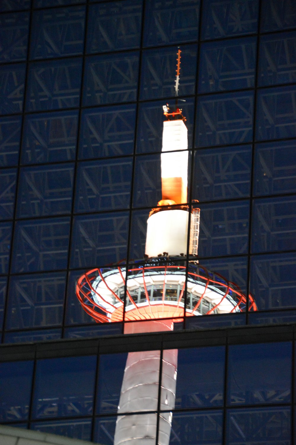 white and orange tower during night time