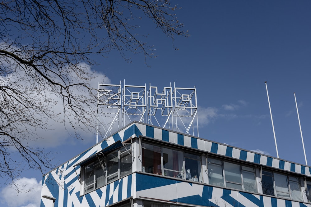 white and blue concrete building near bare trees under blue sky during daytime