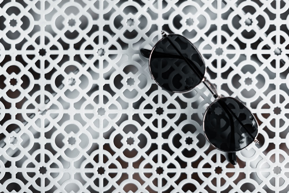 black sunglasses on white and red textile