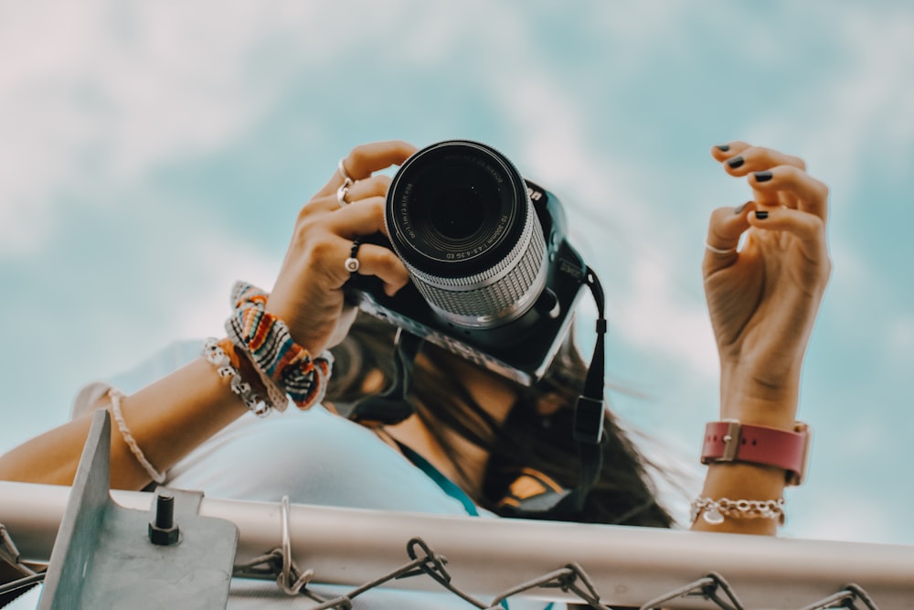 person holding black dslr camera