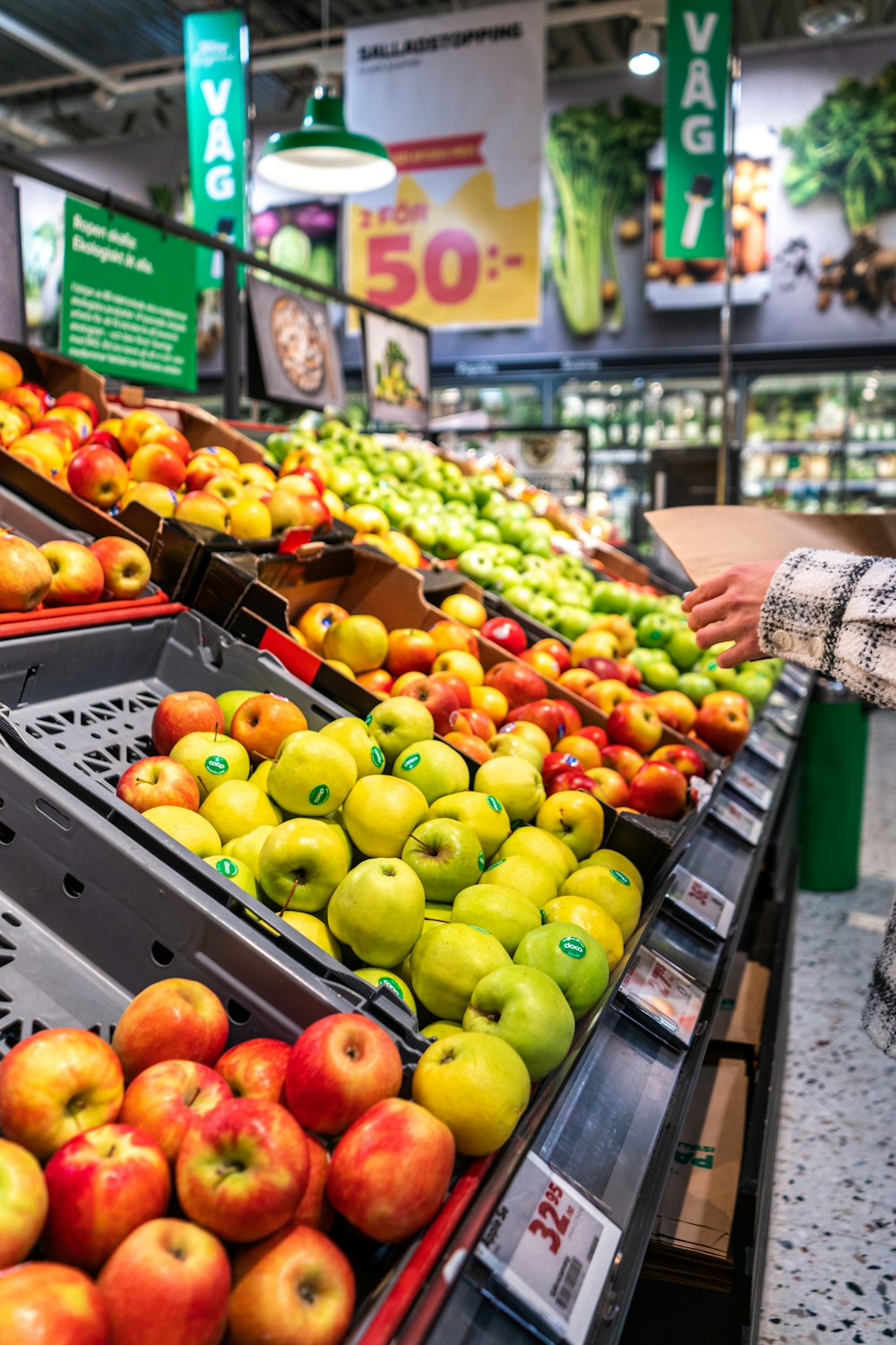 green and red apples on black plastic crate