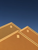 A freshly completed sturdy shingle roof shining under bright sunlight.