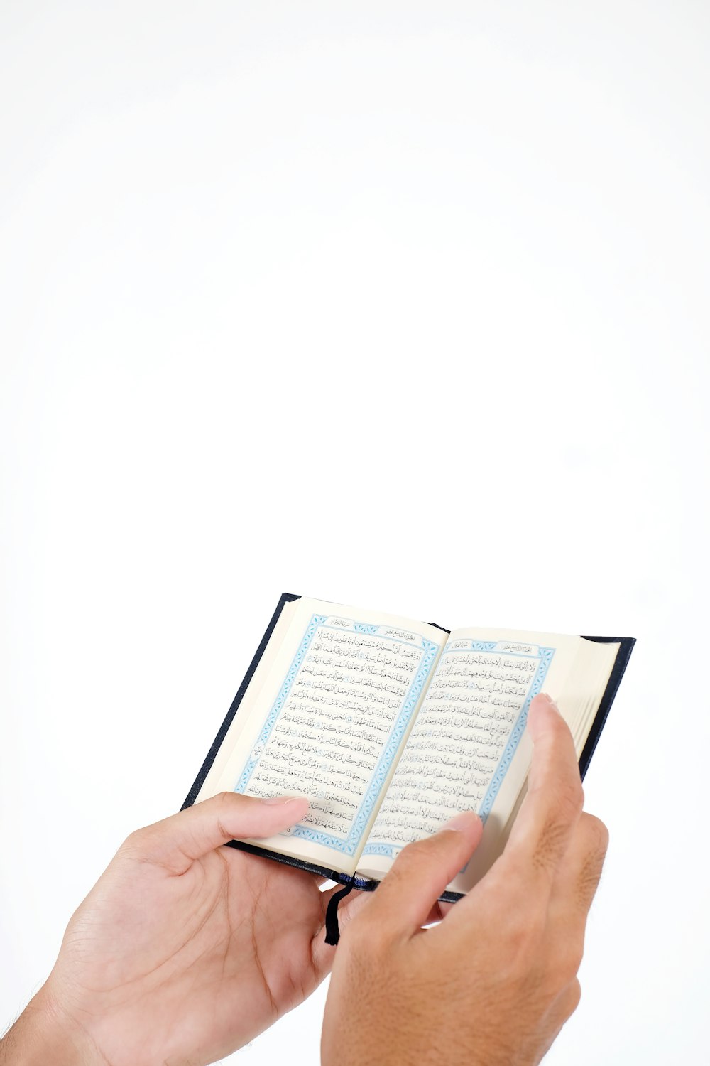 person holding white and brown book