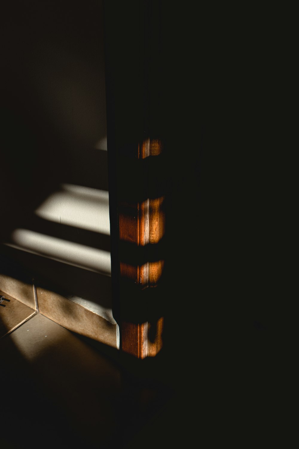 brown wooden frame on black floor tiles