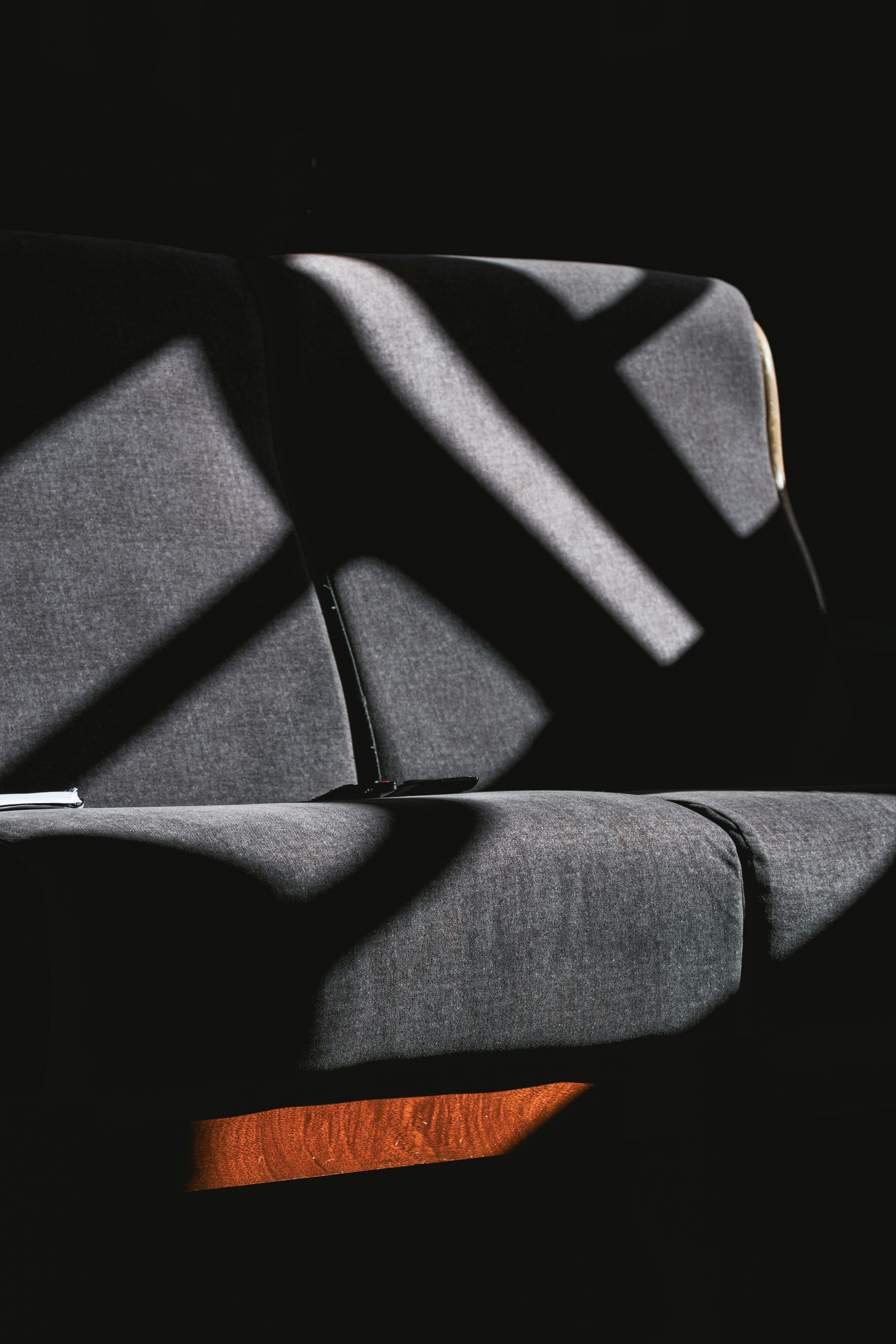 A convertible sofa with adjustable armrests and headrests