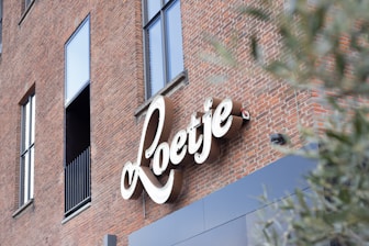 brown brick building with white love neon signage