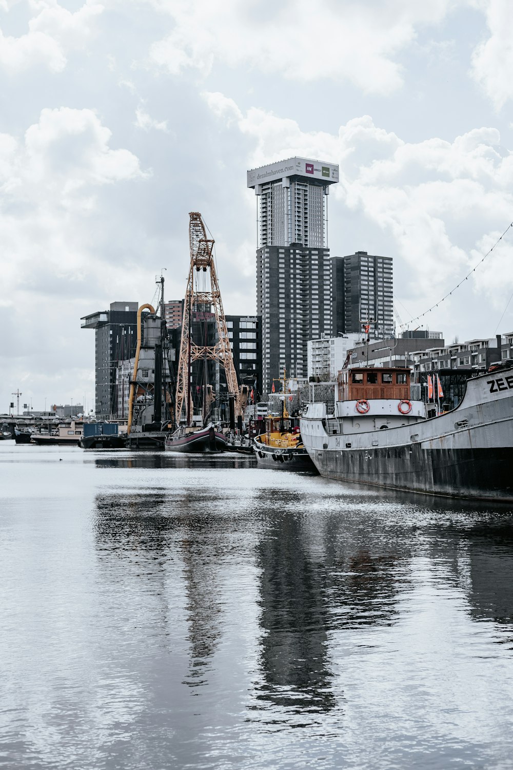white and black ship on water near city buildings during daytime