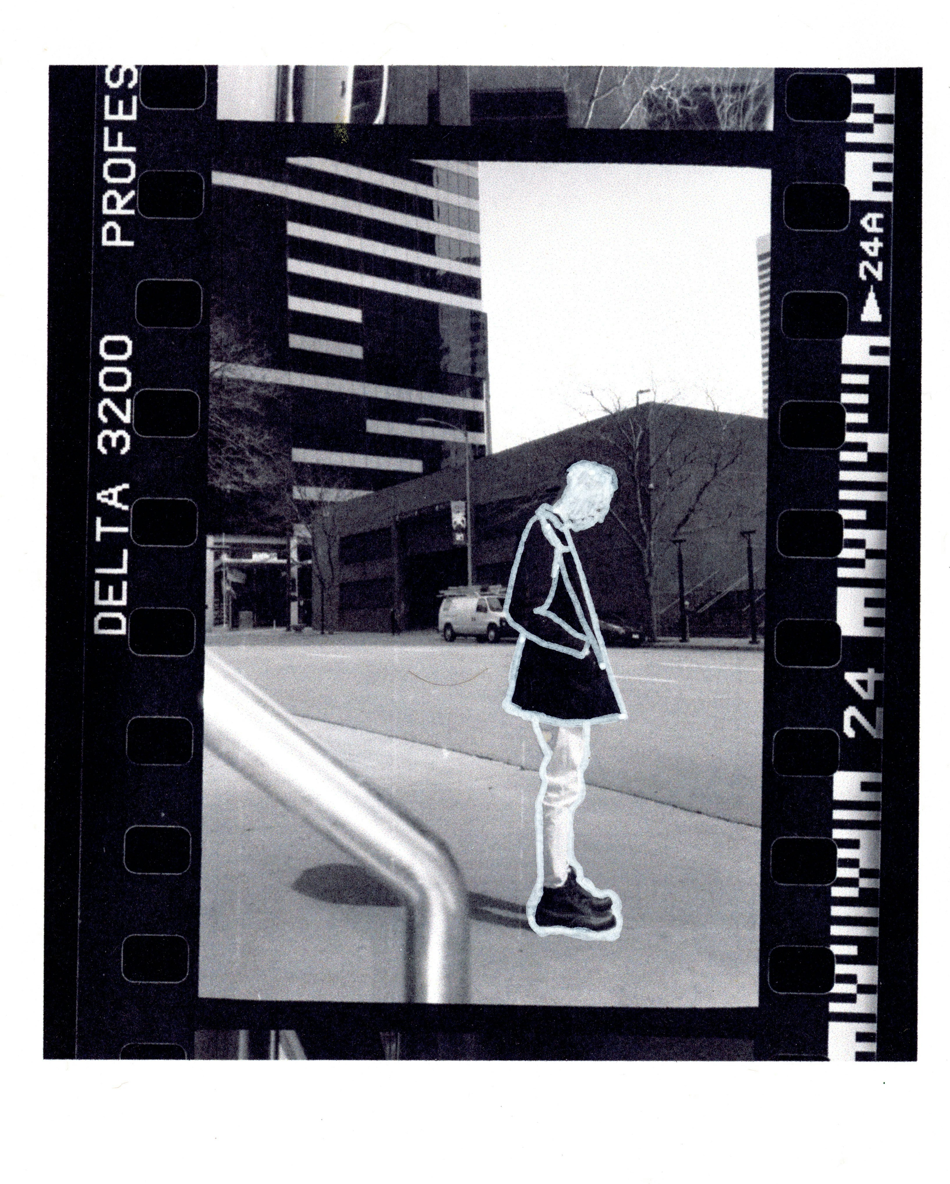 woman in black and white dress walking on sidewalk during daytime