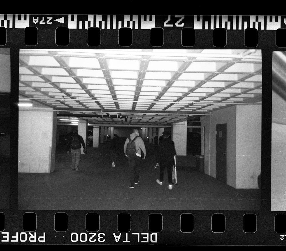 man in black jacket walking on hallway