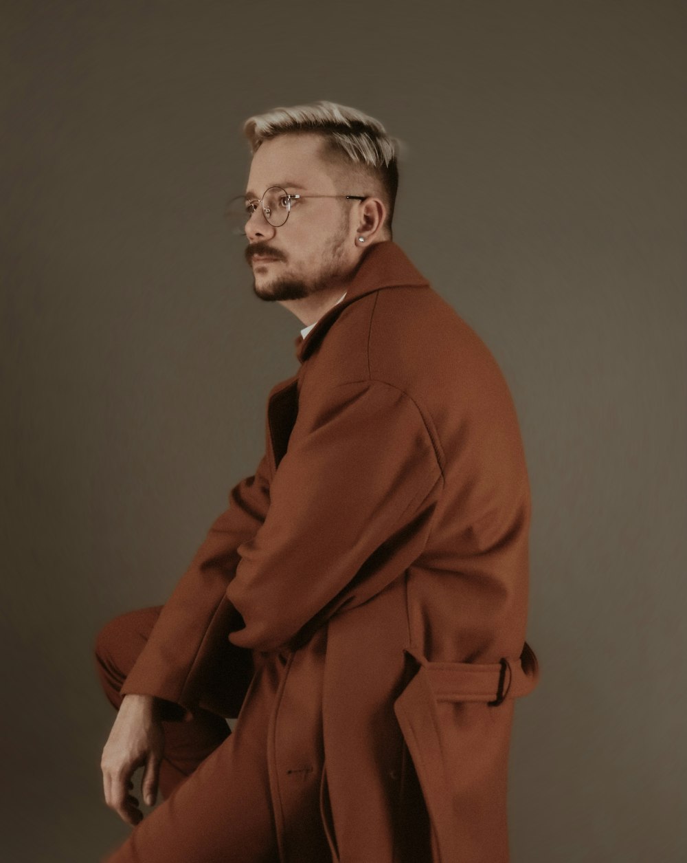 man in brown coat standing