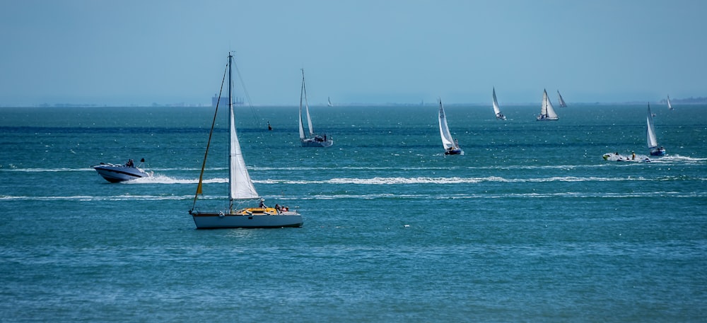 white and brown sail boat on sea during daytime