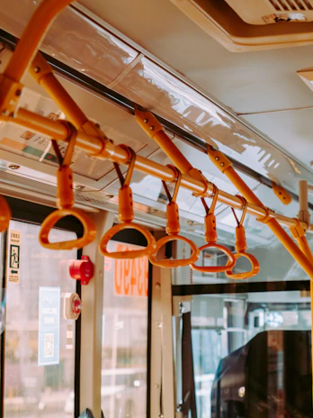 Interior view of a Vialume bus showing comfortable seating and handrails.