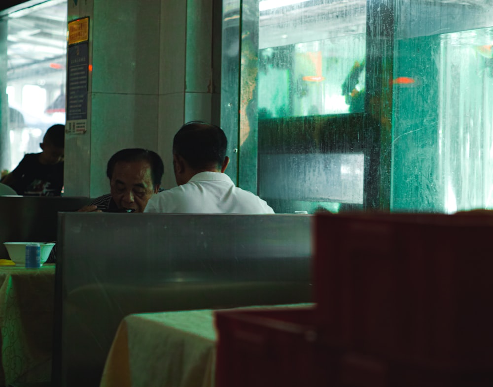 man in white dress shirt sitting on chair