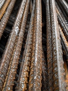 Close-up of steel rods stacked neatly in a warehouse