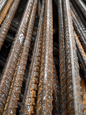 Close-up of steel reinforcement bars treated with cathodic corrosion protection on a construction site.