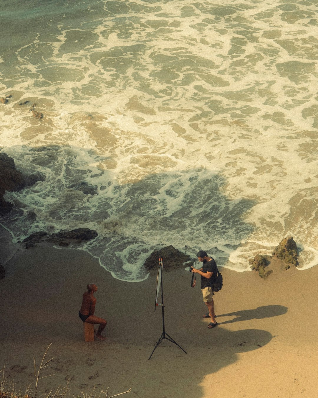 2 men standing on beach shore during daytime