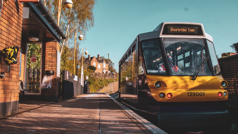 yellow and black tram on road during daytime