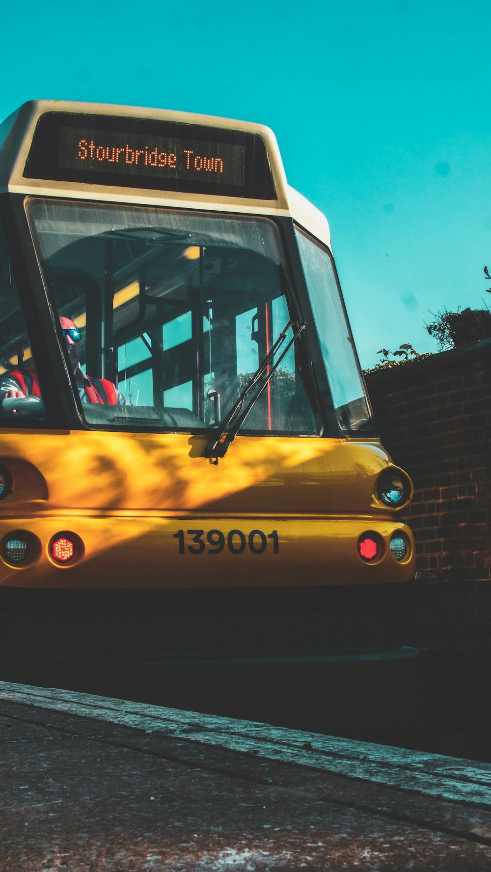 yellow and black bus on road during daytime