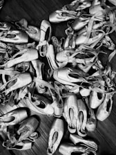 A group of young dancers smiling while holding donated pointe shoes.