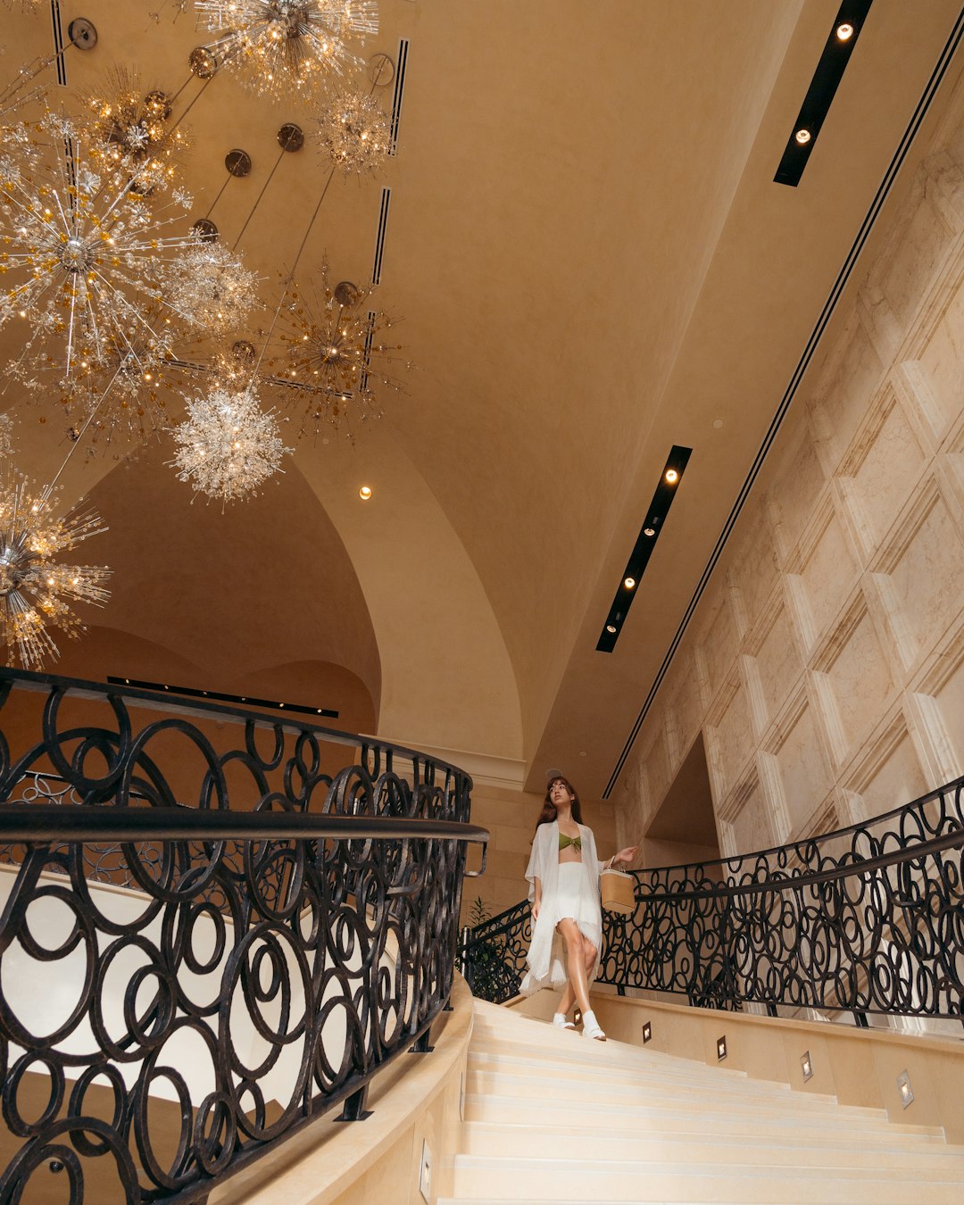 woman in white wedding dress standing on staircase