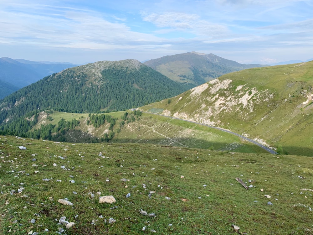 green grass field and mountains during daytime