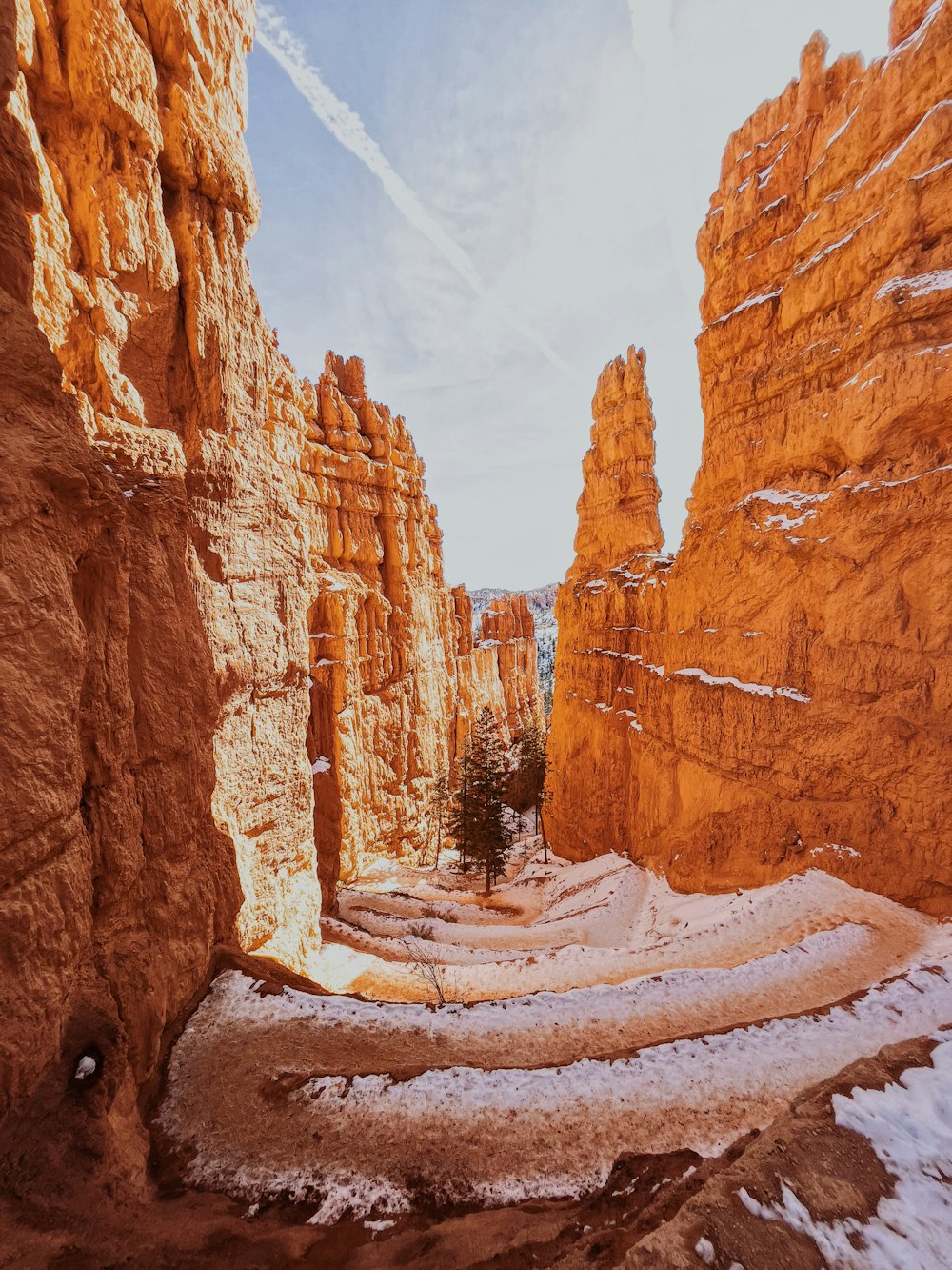 brown rock formation under white clouds during daytime