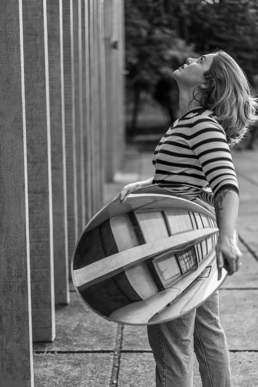 grayscale photo of woman in striped shirt and skirt