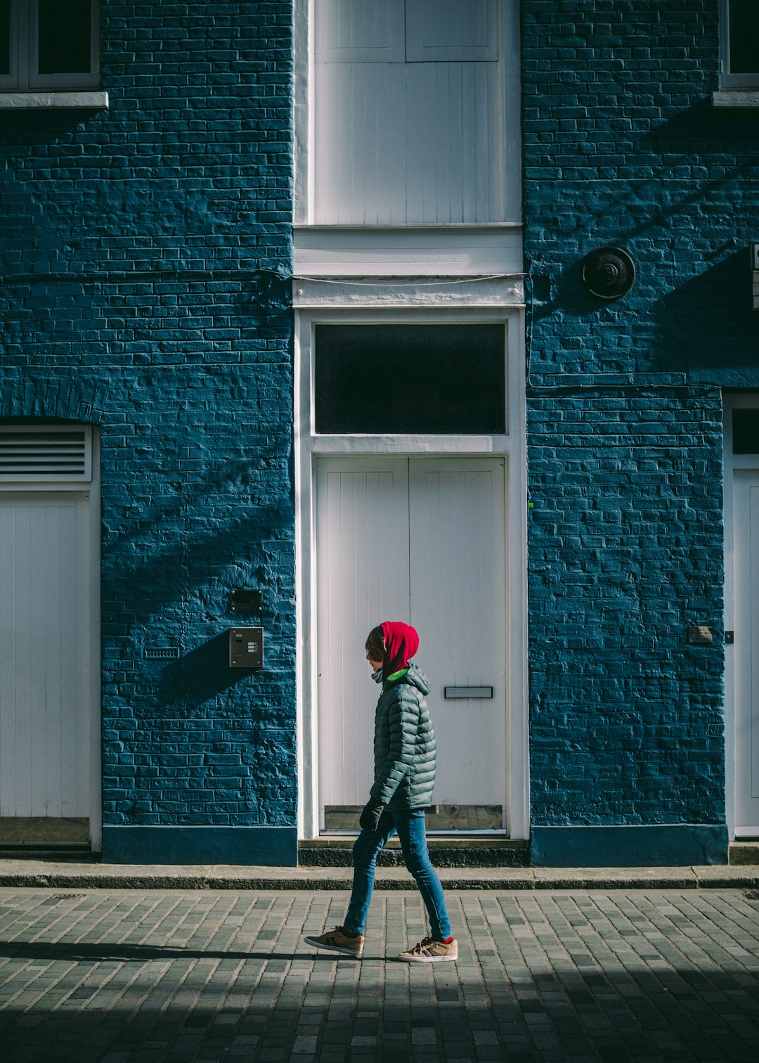 man in black and white striped long sleeve shirt and black pants holding red balloon