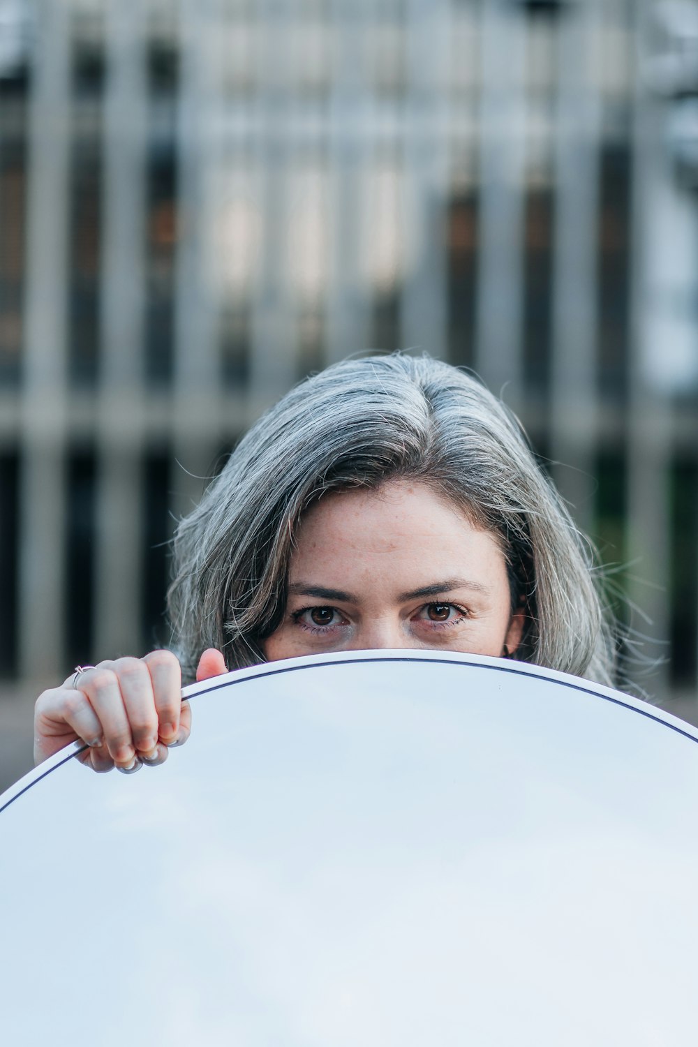 woman holding white round plate